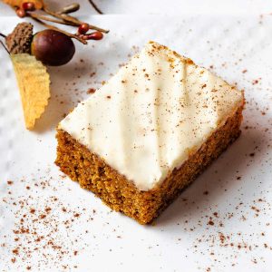 a Libby's pumpkin bar with cream cheese icing on a plate sprinkled with cnnamon.