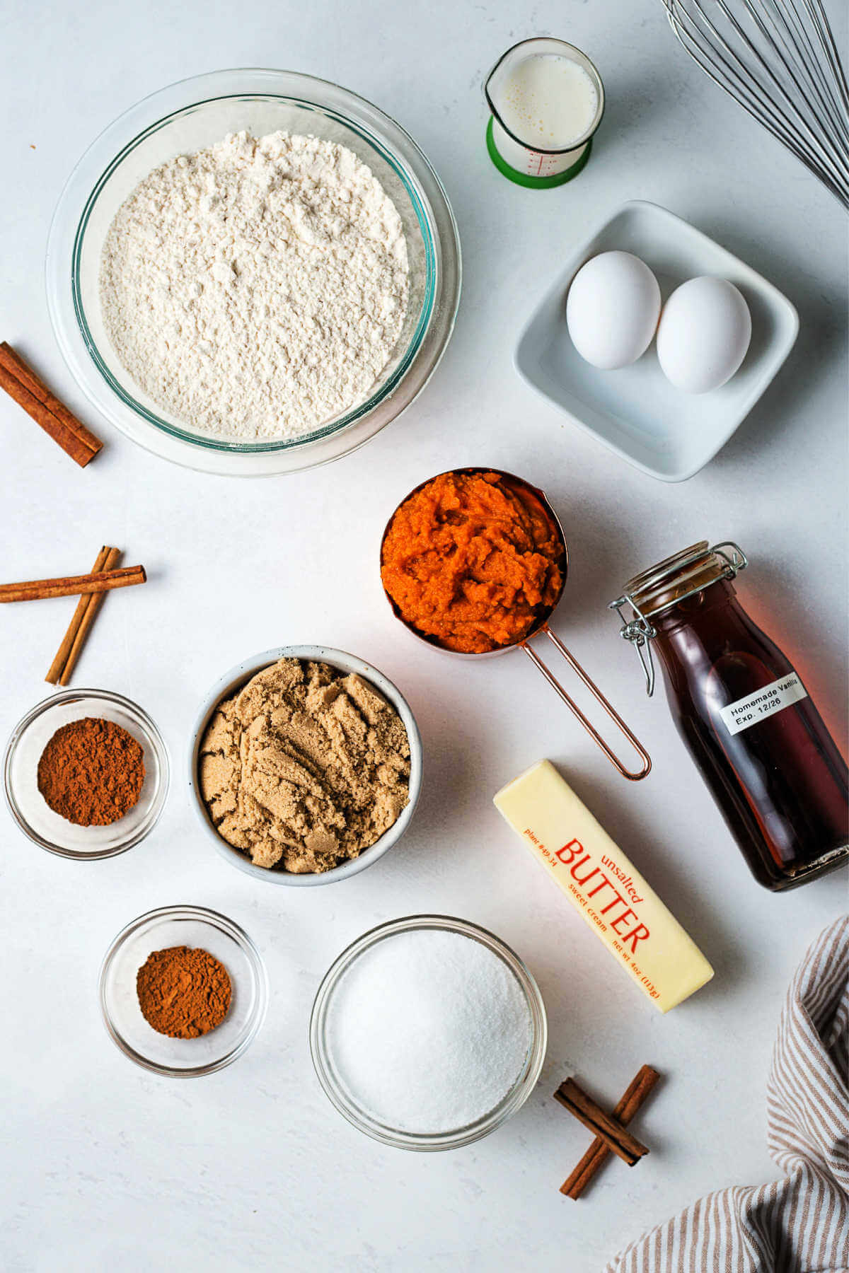 ingredients for baked pumpkin donuts on a table.