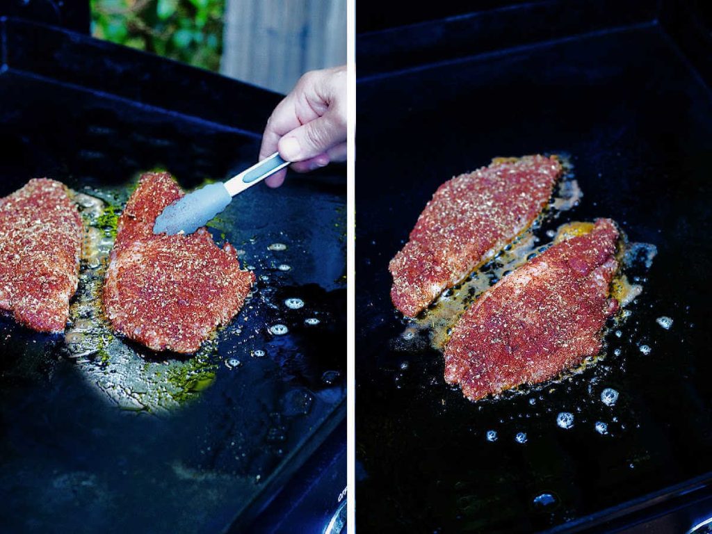 placing catfish filets on a hot griddle.