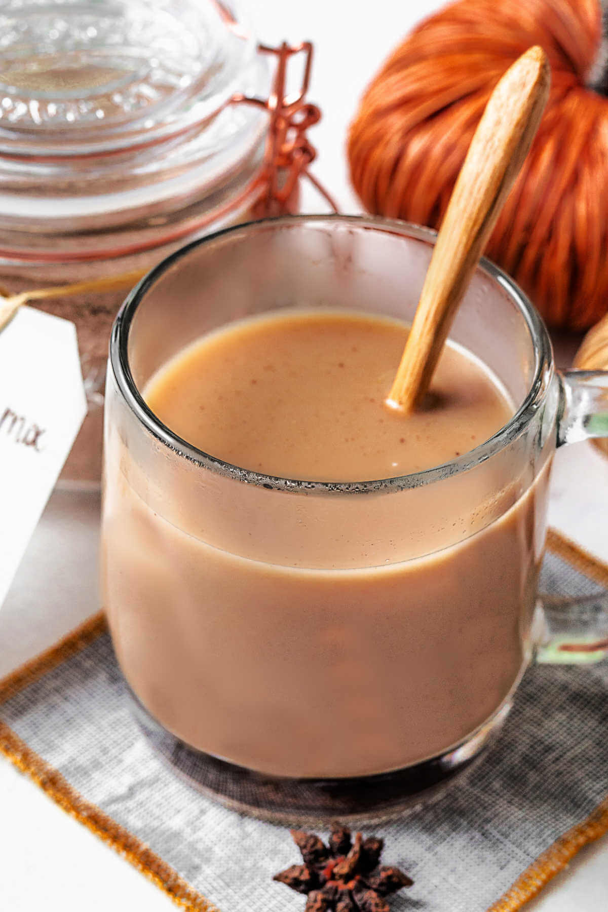 chai tea in a glass mug on a coaster.