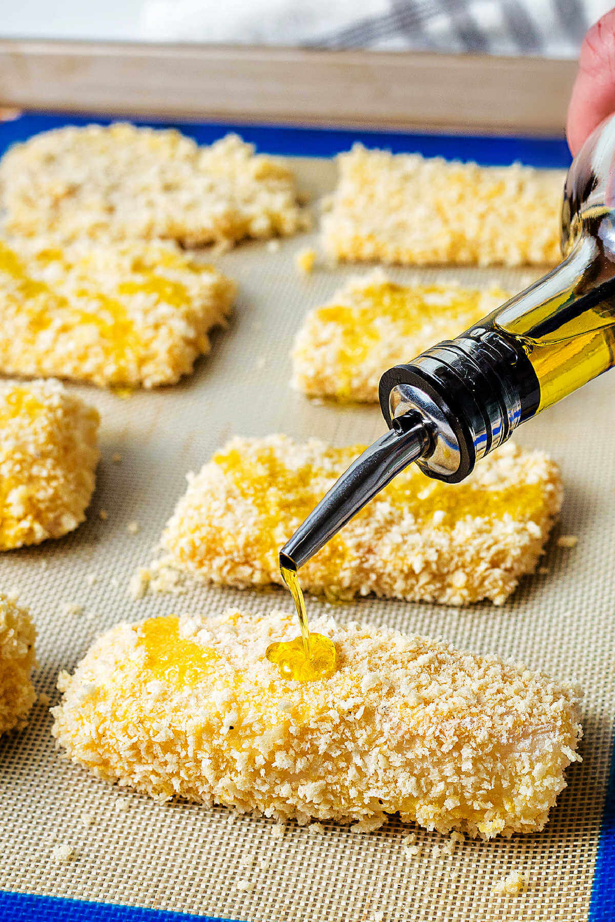 drizzling olive oil on breaded fish filets prior to baking.