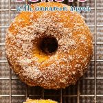 Pumpkin Donuts with Cinnamon Sugar on a cooling rack.