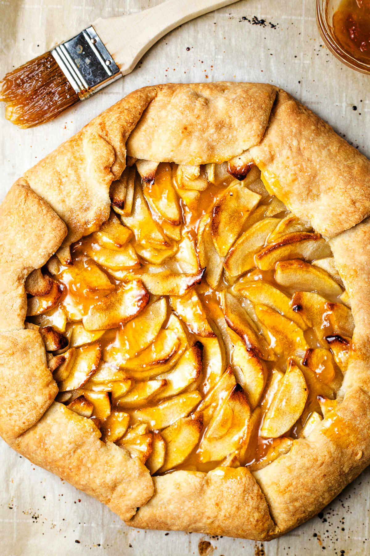 an apple tart glazed with melted apricot jam.