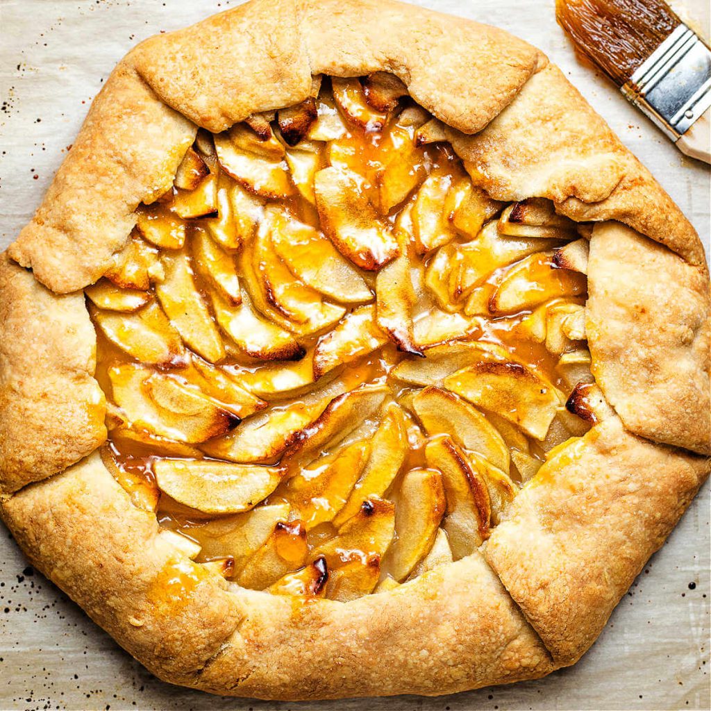 Rustic French Apple Tart on parchment paper.