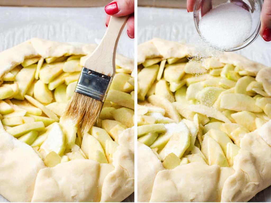 brushing apples with butter and sugar before baking a rustic French apple tart.