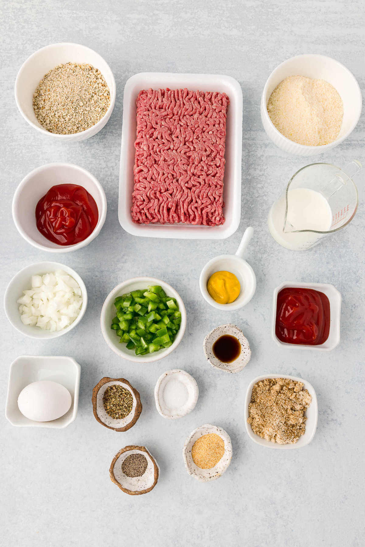 ingredients for mini meatloaf muffins on a table.