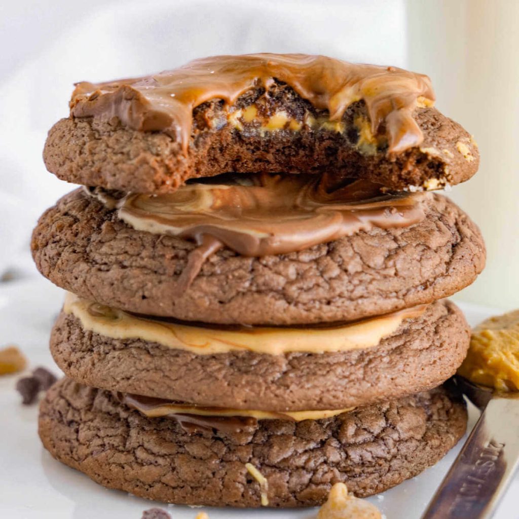 fudgy peanut butter brownie cookies stacked on top of each other.