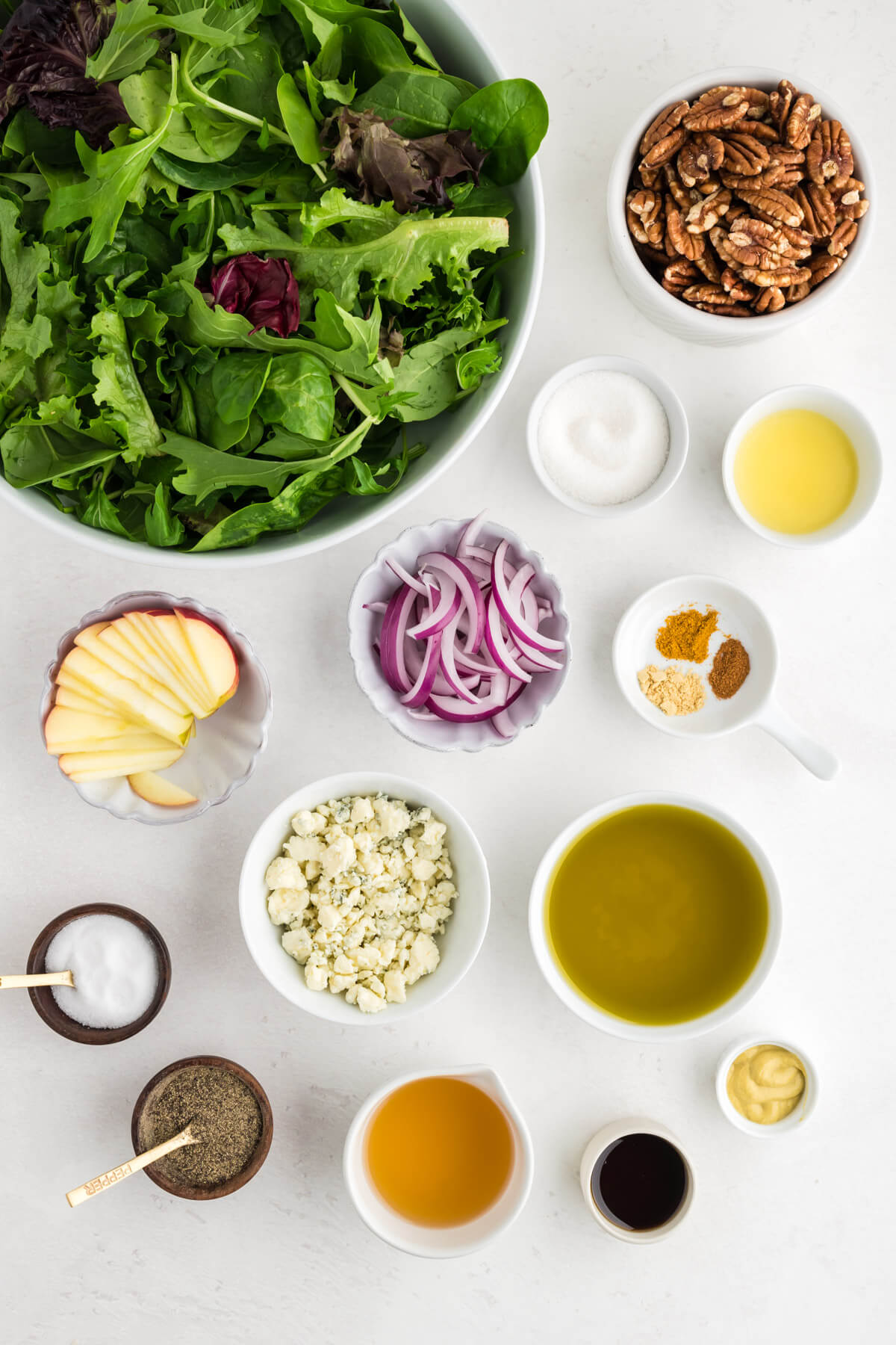ingredients for winter salad and a vinaigrette on a table.