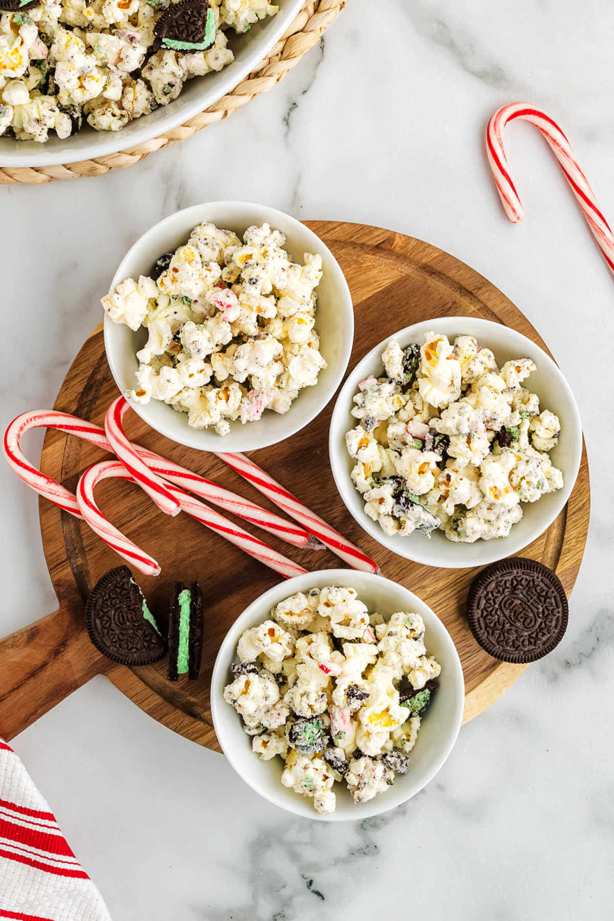 white chocolate popcorn in individual serving bowls on a table.
