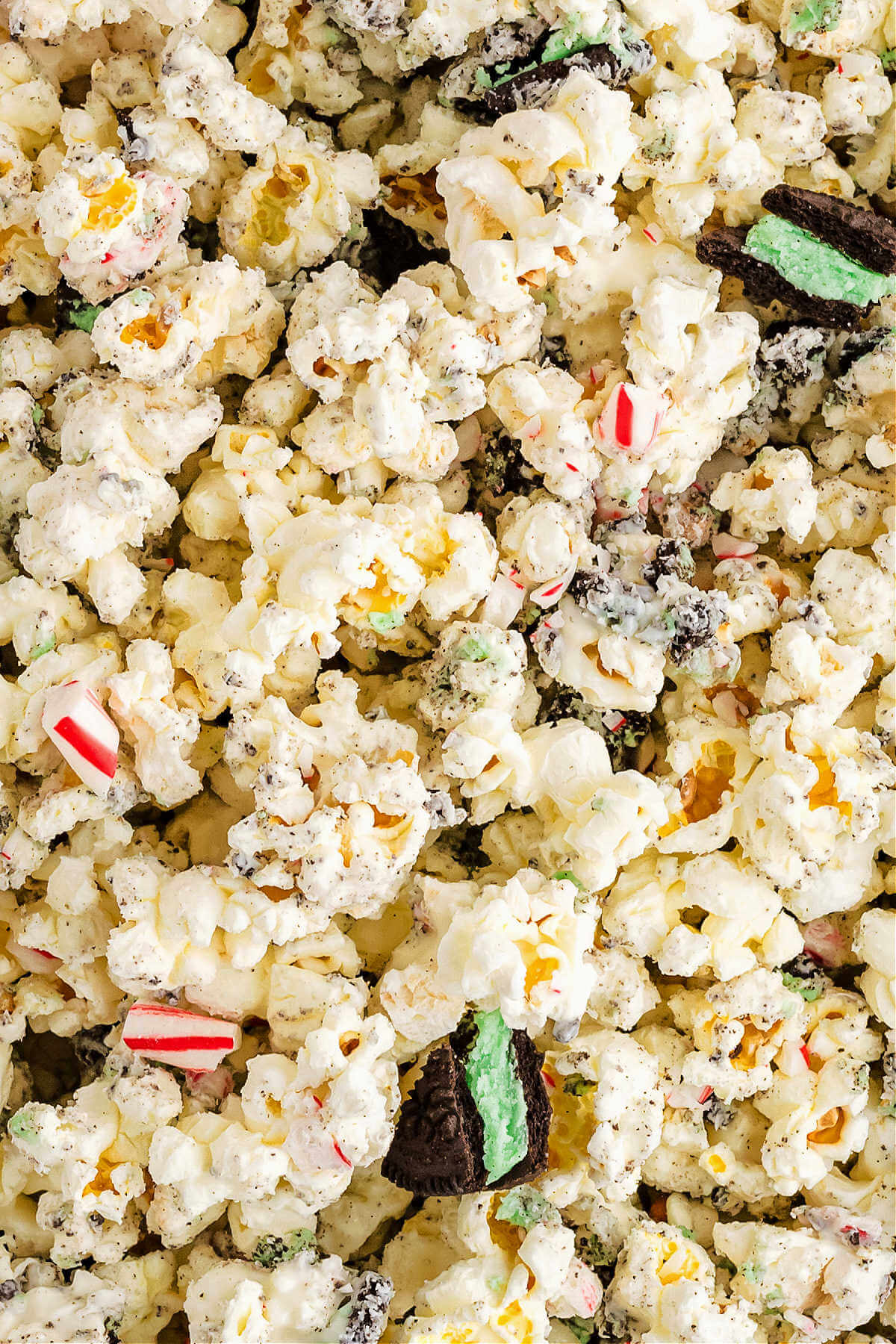close up image of popcorn with peppermint and oreos in a vanilla candy coating.