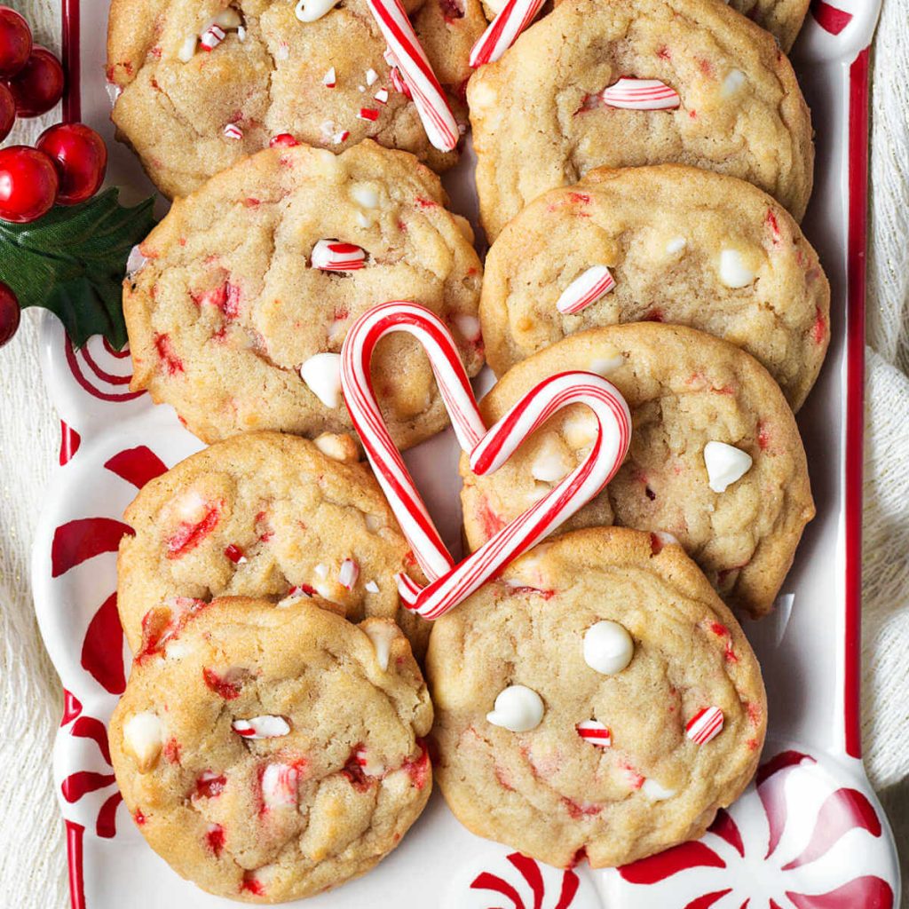 white chocolate chip peppermint cookies on a plate with candy canes.
