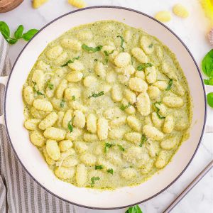 gnocchi with pesto sauce in a bowl on a table,