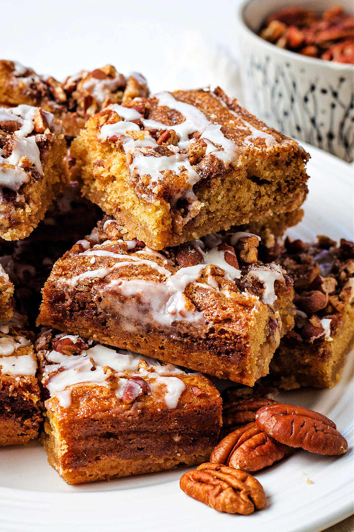 brown sugar pecan coffee cake stacked on a plate on a table.