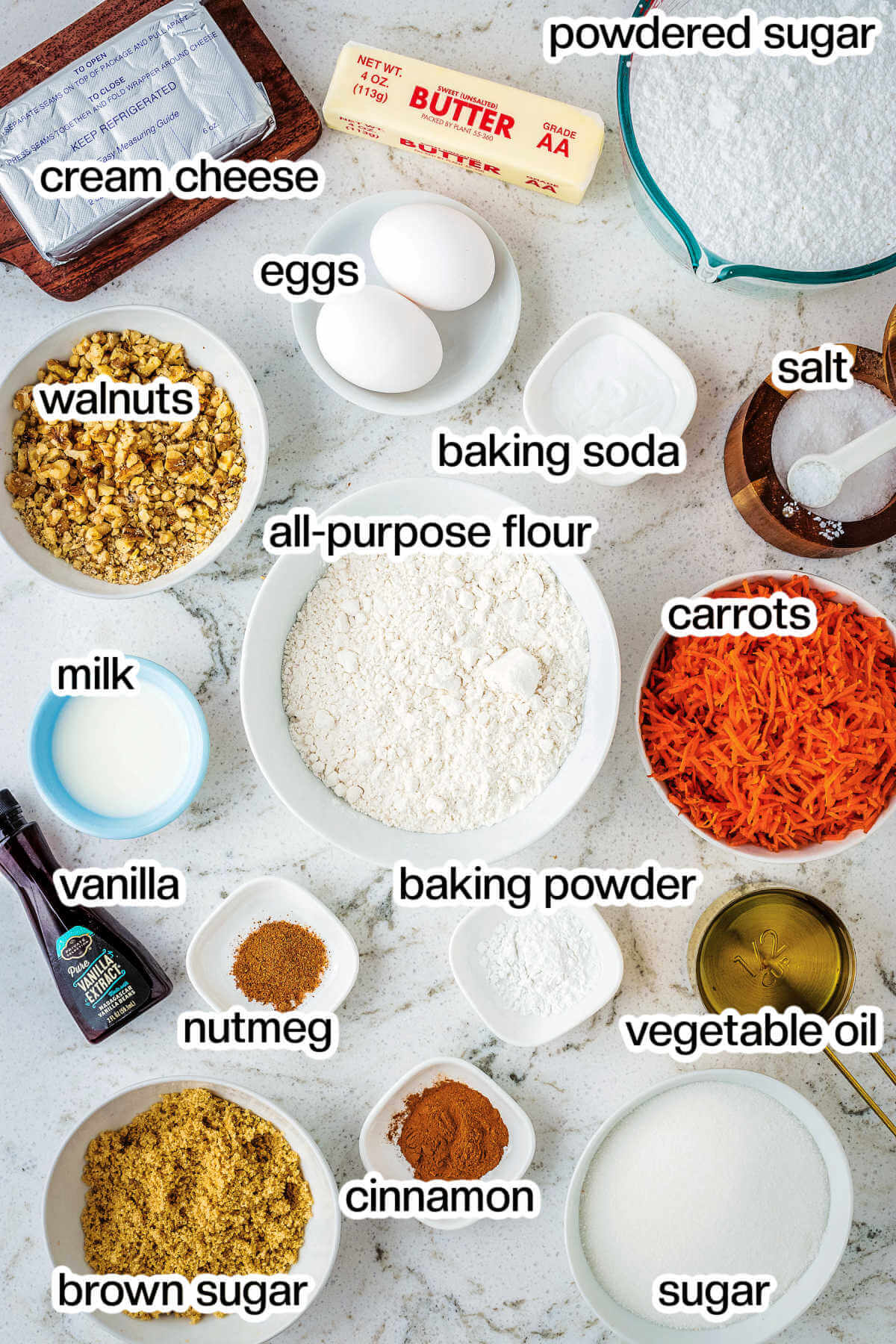 ingredients for carrot cake muffins on a table.
