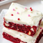 Red Velvet Brownies with Cream Cheese Frosting on a plate.
