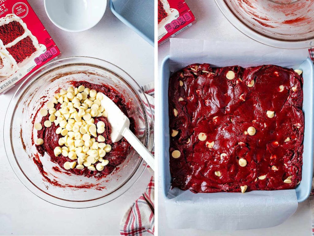 folding white chocolate chips into red velvet brownie batter and spreading it into a pan lined with parchment paper.