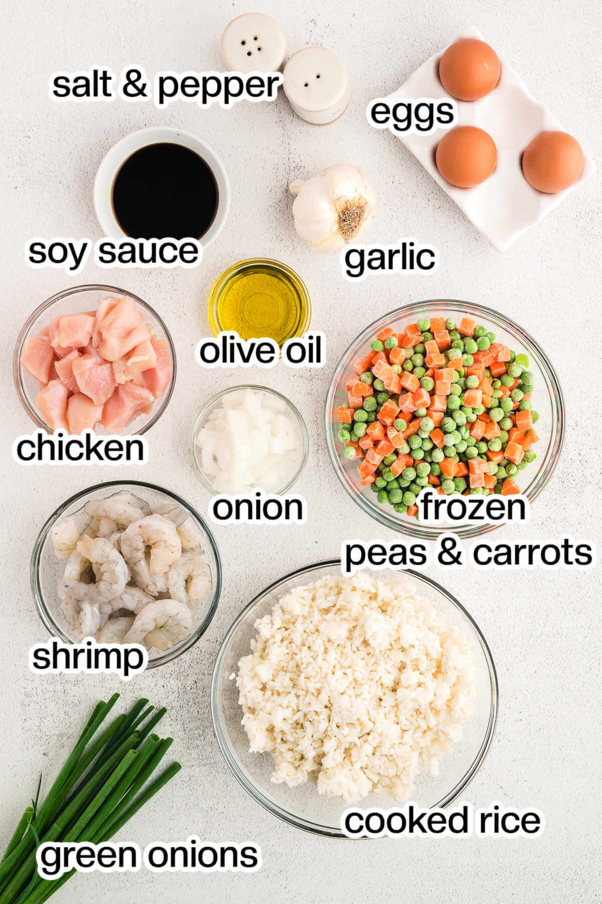 Ingredients for shrimp and chicken fried rice on a table.