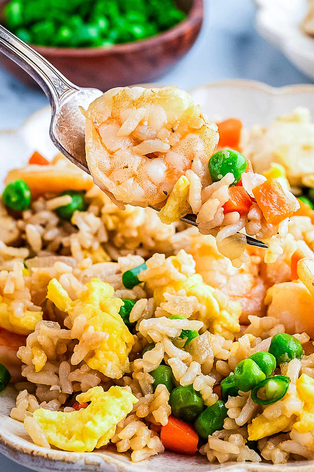 a bite of shrimp and chicken fried rice on a fork.