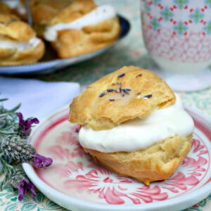 Lavender Cream Puff on a china plate on a table.