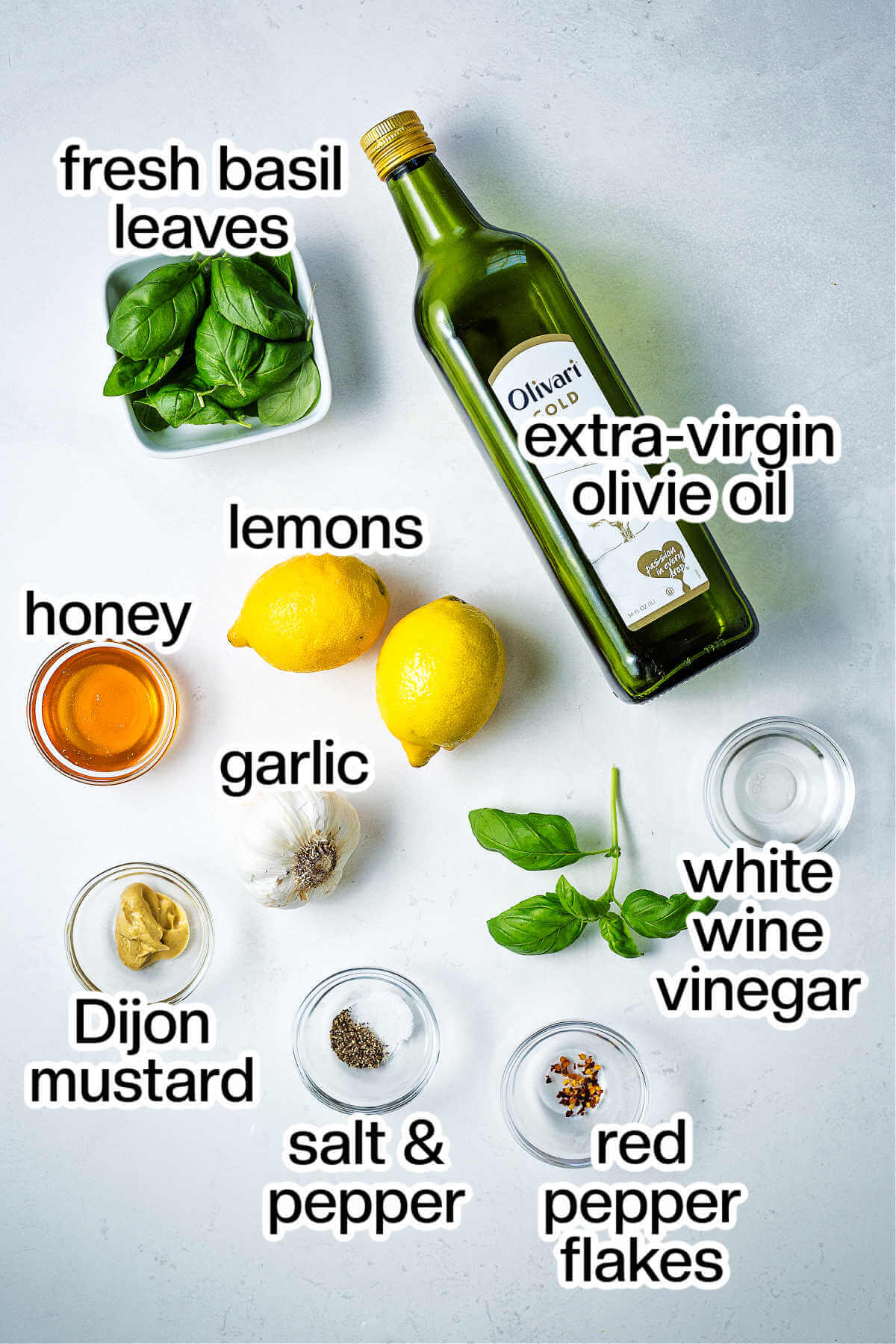 Ingredients for making lemon basil dressing on a table.