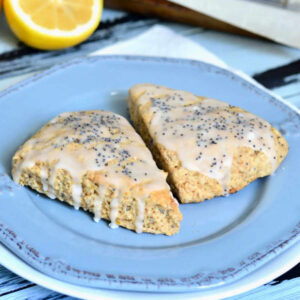 Lemon Poppy Seed Scones on a blue plate on a table.