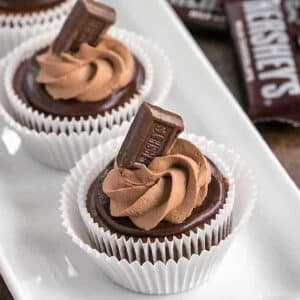 Mini Chocolate Cheesecakes garnished with a hershey bar candy.