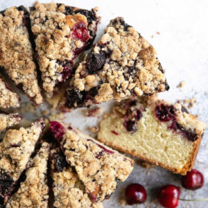 Slices of cherry crumb cake on a table.