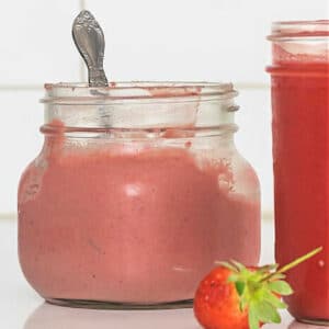 Strawberry Curd in a jar on a counter.