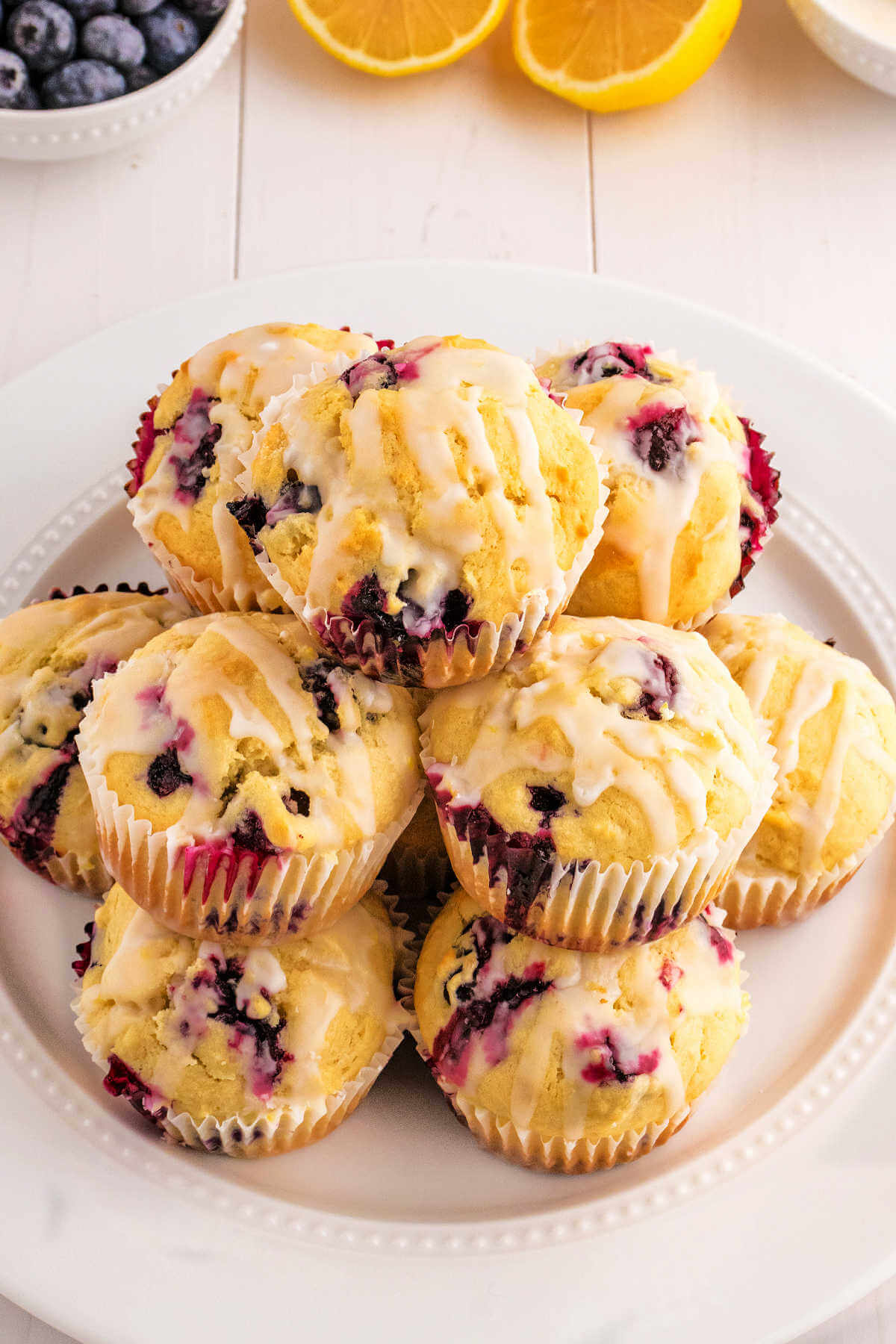 A plate of lemon blueberry muffins on a table.