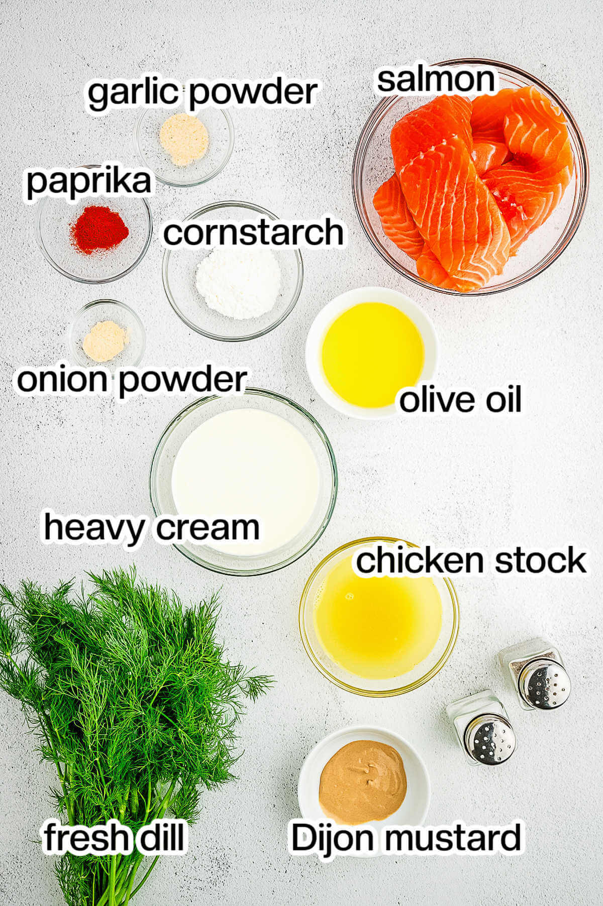 Ingredients for cooking salmon with a dill cream sauce on a table.