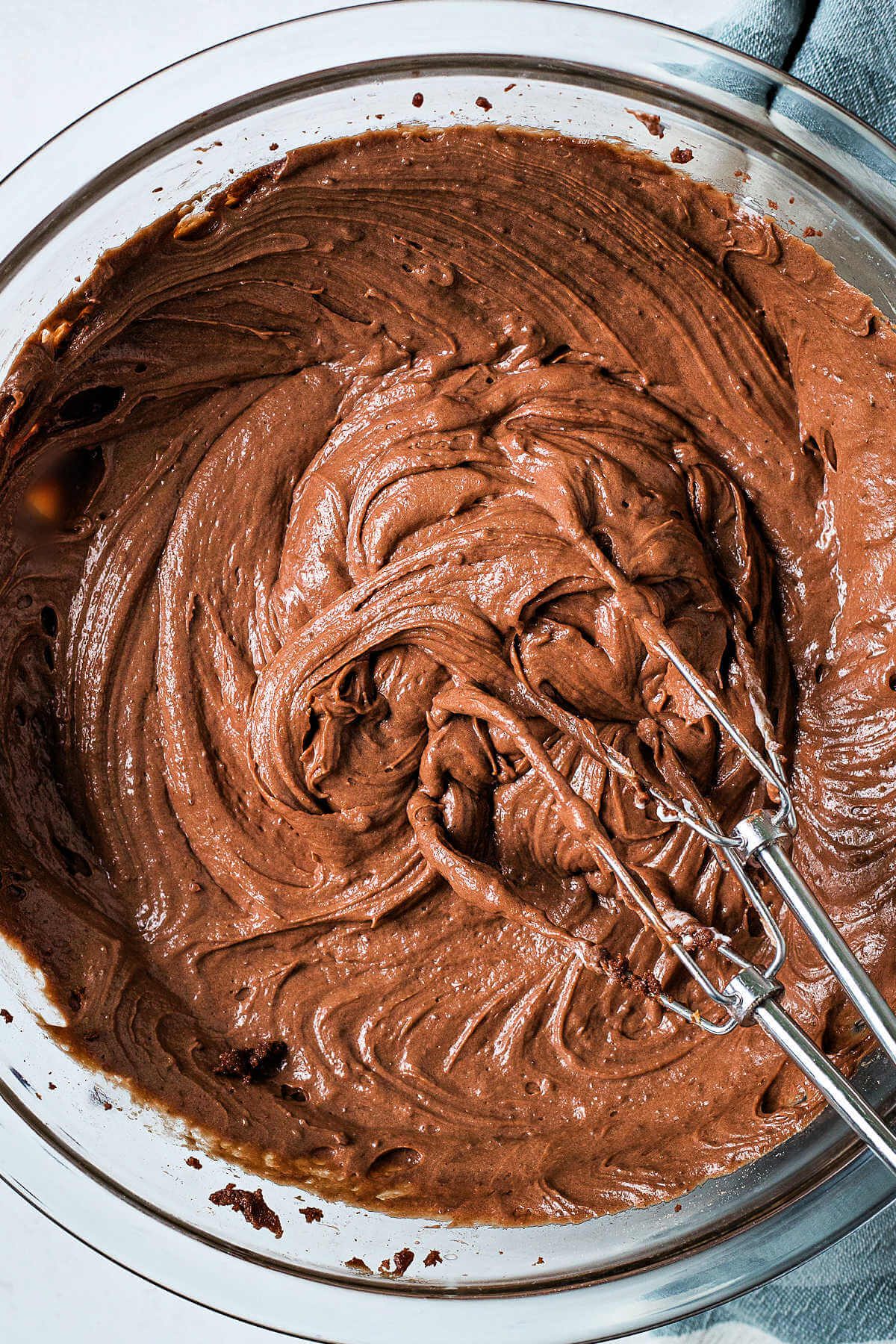 Brownie batter dip creamed together in a glass bowl on a table.