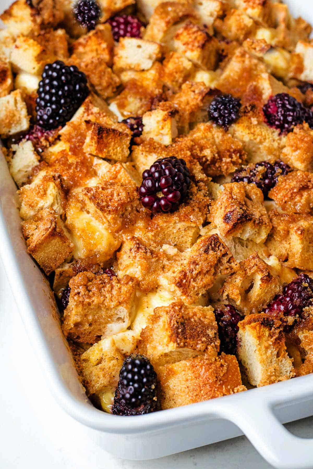 Close up view of French Toast Casserole in a baking dish on a table.