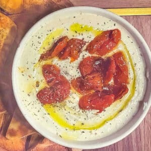 Whipped feta with roasted cherry tomatoes on top.