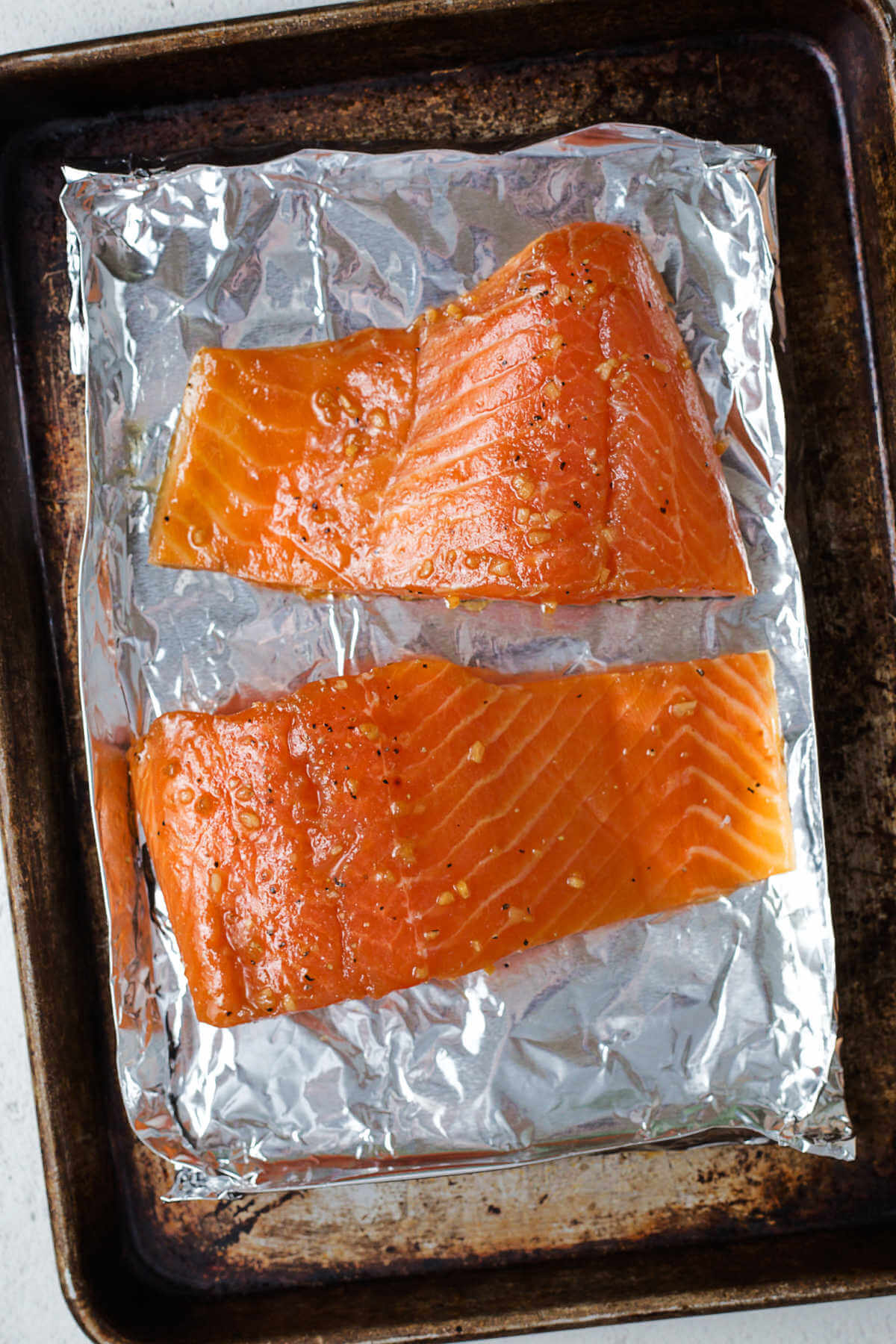 Marinated salmon on an aluminum foil boat ready for the grill.