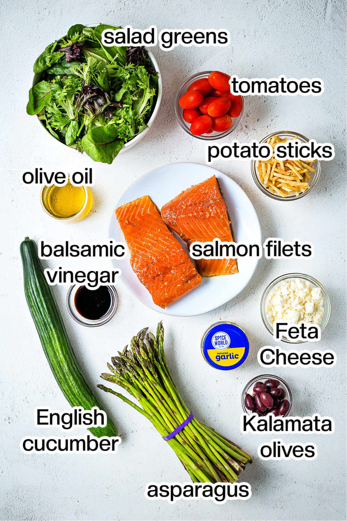 Ingredients for salmon and salad on a table.