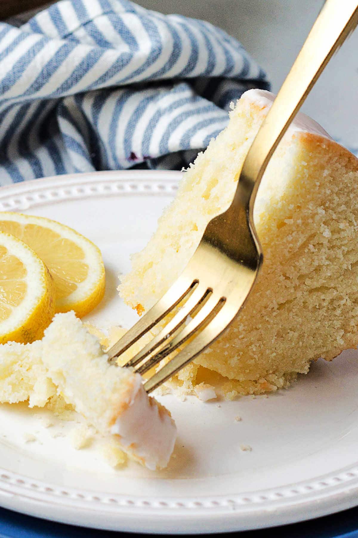 A partially eaten slice of cake on a plate on a table.