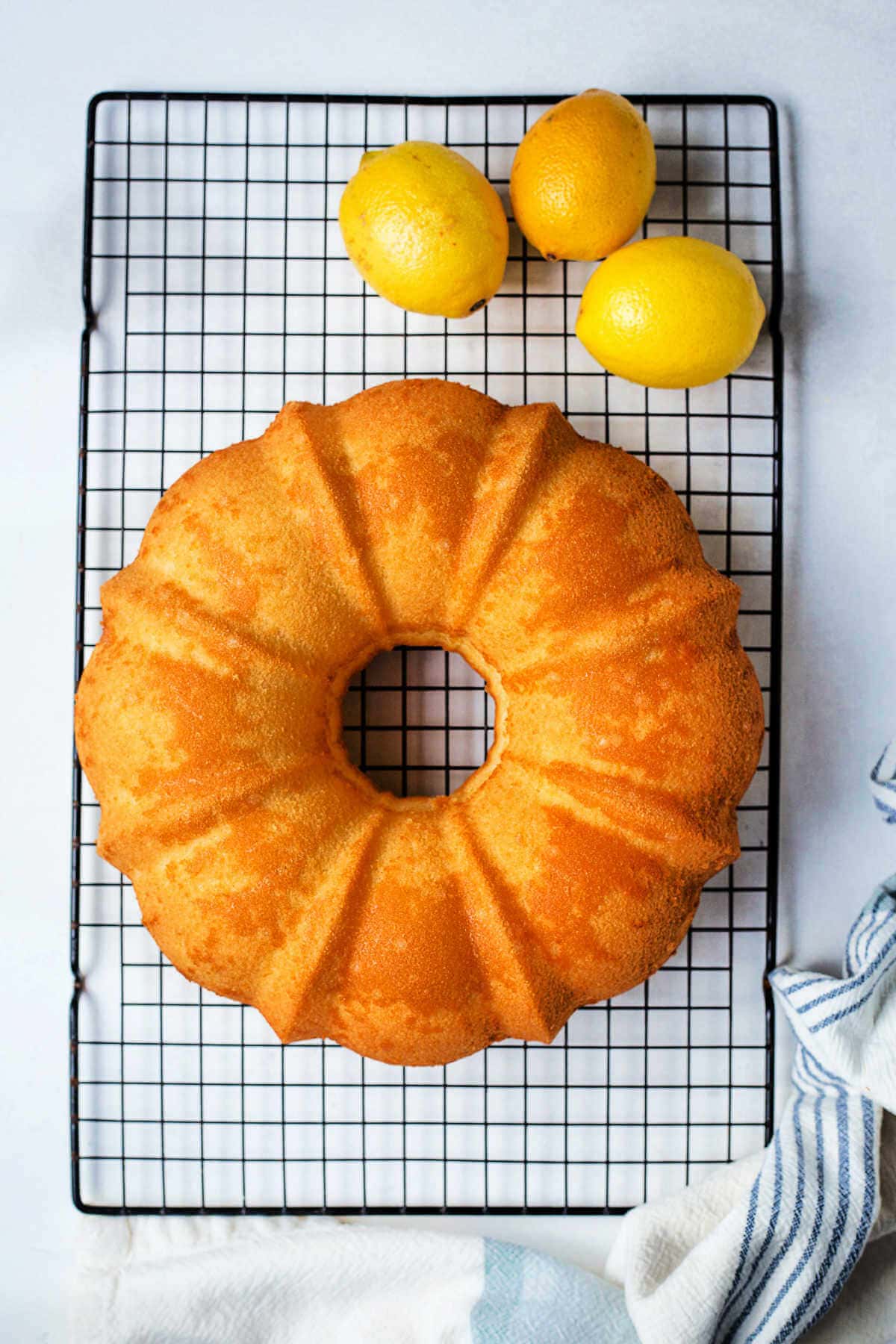 A Bundt cake on a wire cooling rack on a table.