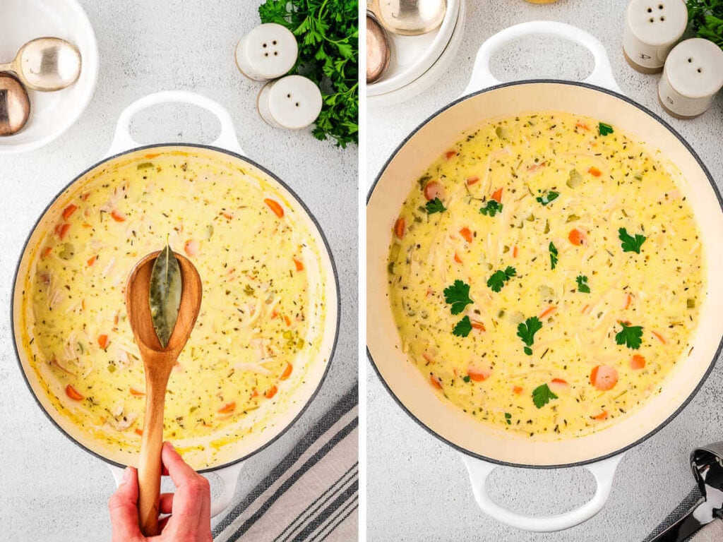 A wooden spoon removing a bay leaf from a pot of creamy turkey noodle soup.