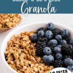 Air Fryer Granola in a bowl topped with fresh berries.