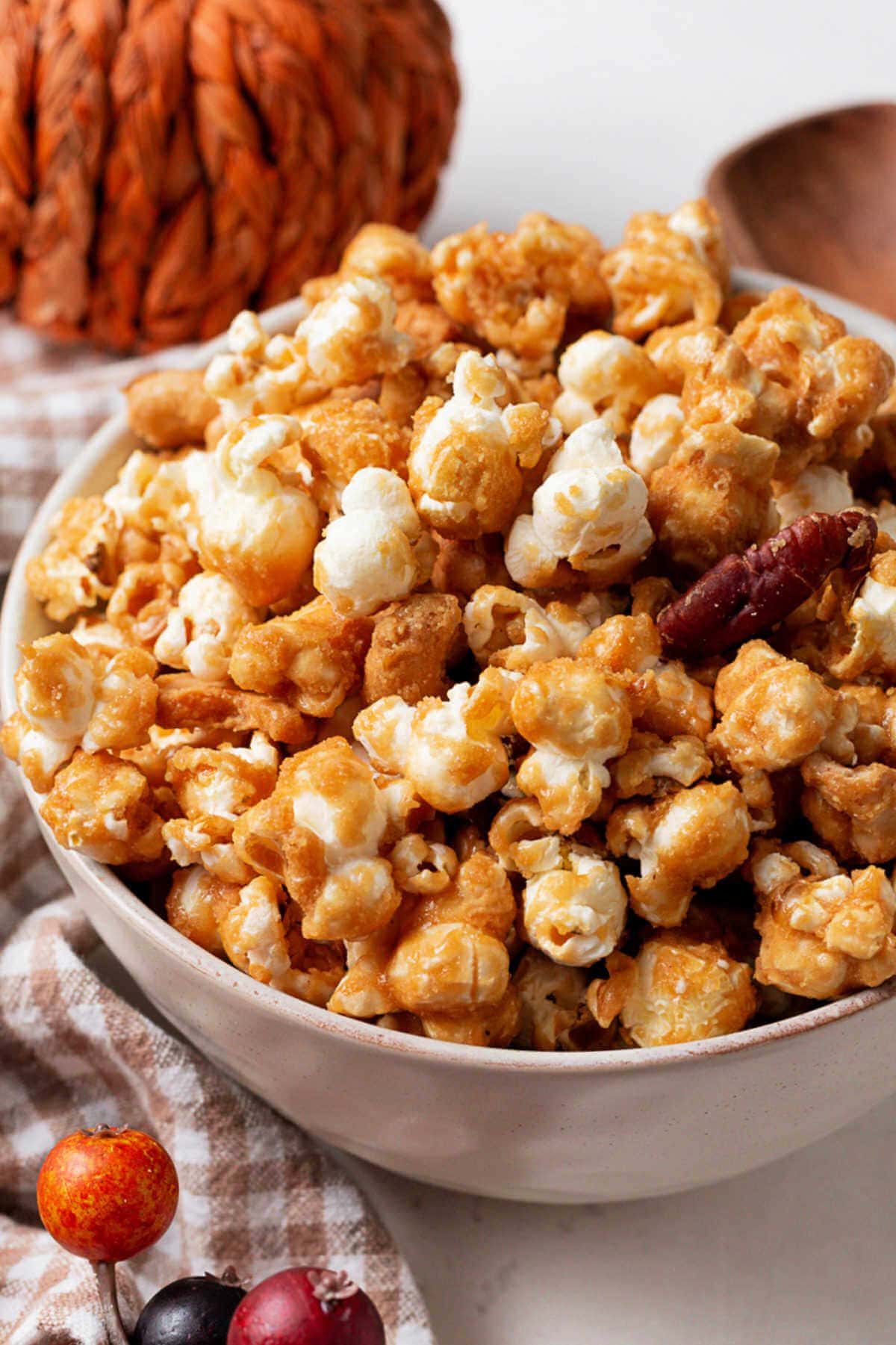 Caramel corn piled up in a bowl on a table.