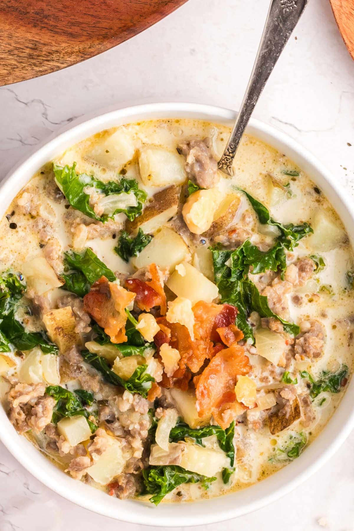 Soup in a bowl with a serving spoon on a table.