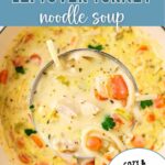 Creamy Turkey Noodle Soup in a bowl with a ladle on a table.