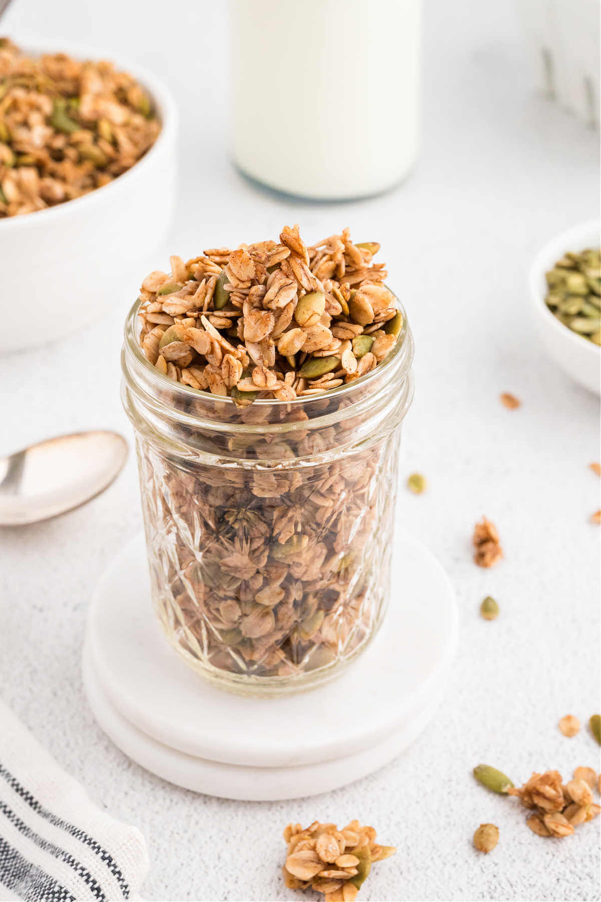 Granola in a glass jar on a table.