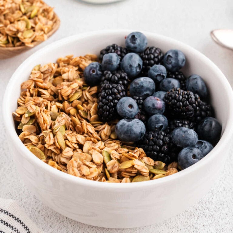 Close up image of a bowl of granola on a table.