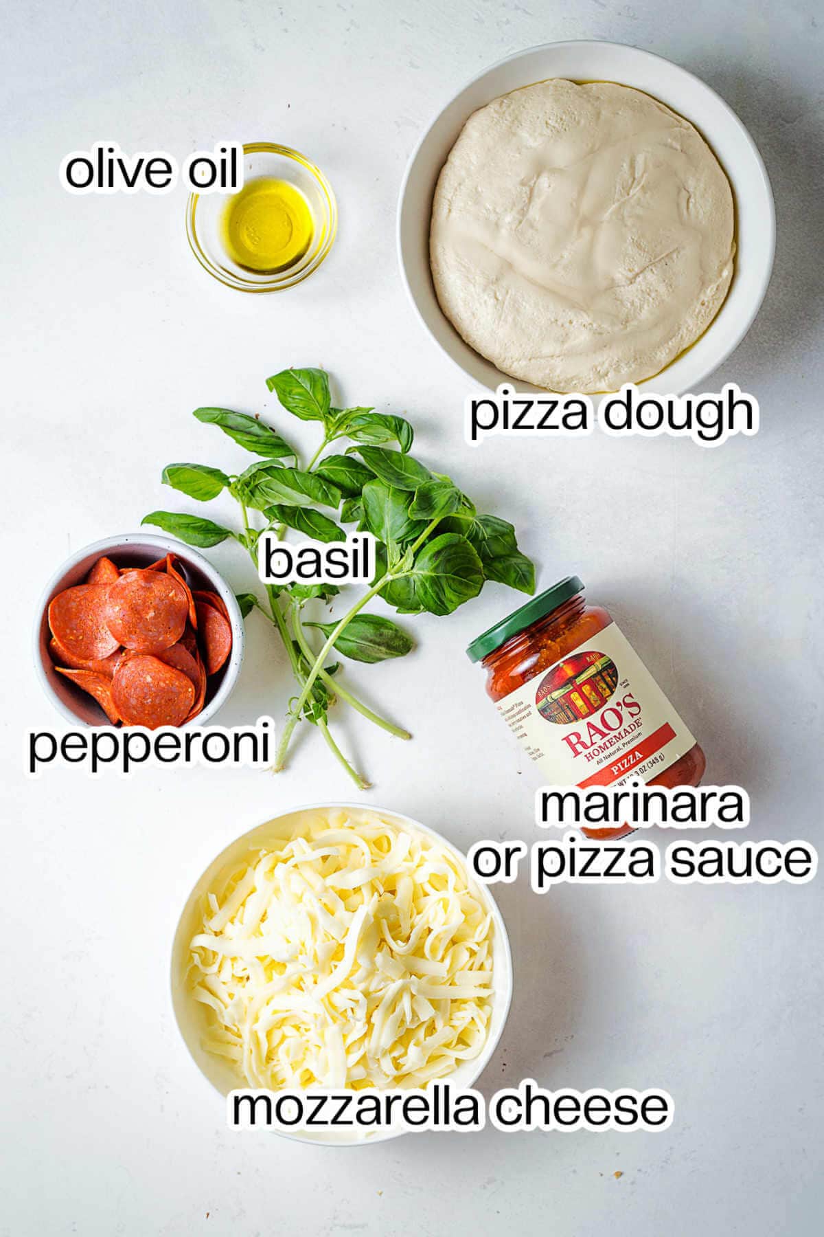 Ingredients for cast iron skillet pizza on a table.