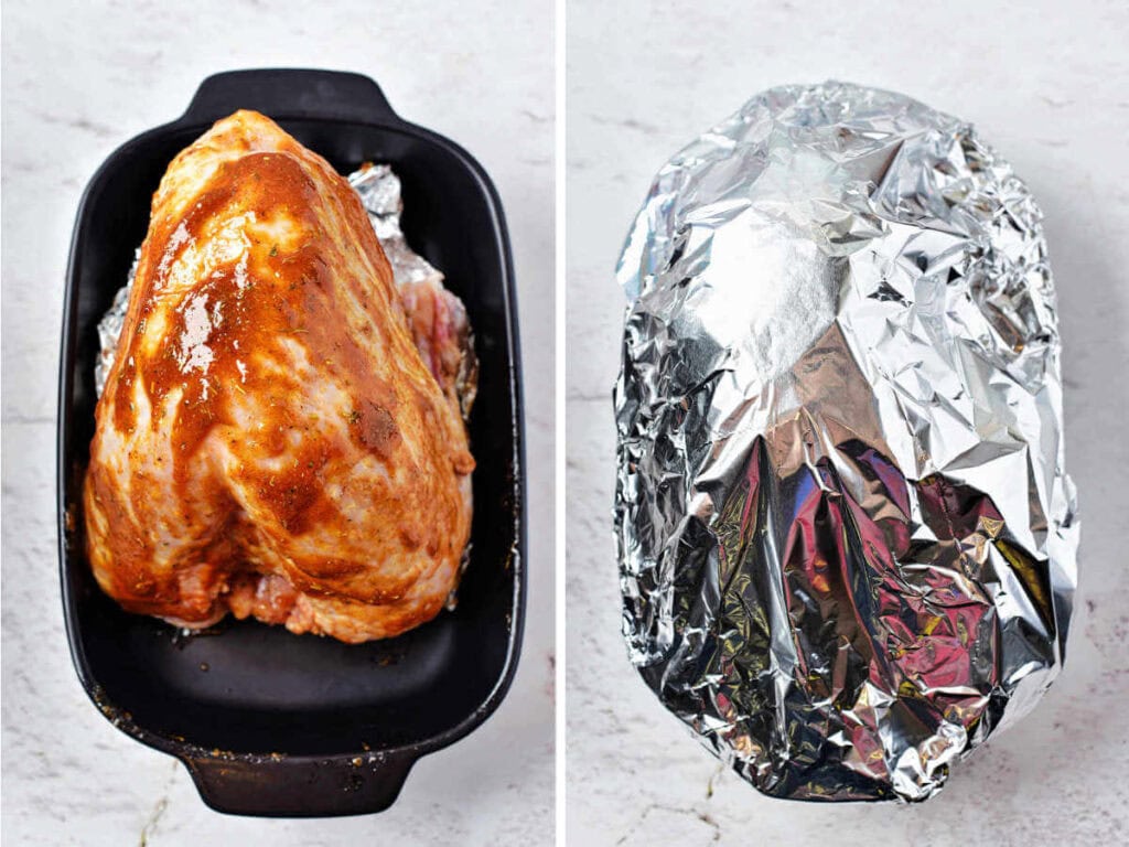 A whole turkey breast in a baking dish brushed with marinade and tented with aluminum foil.