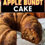 Apple bundt cake on a cake stand with a slice missing.