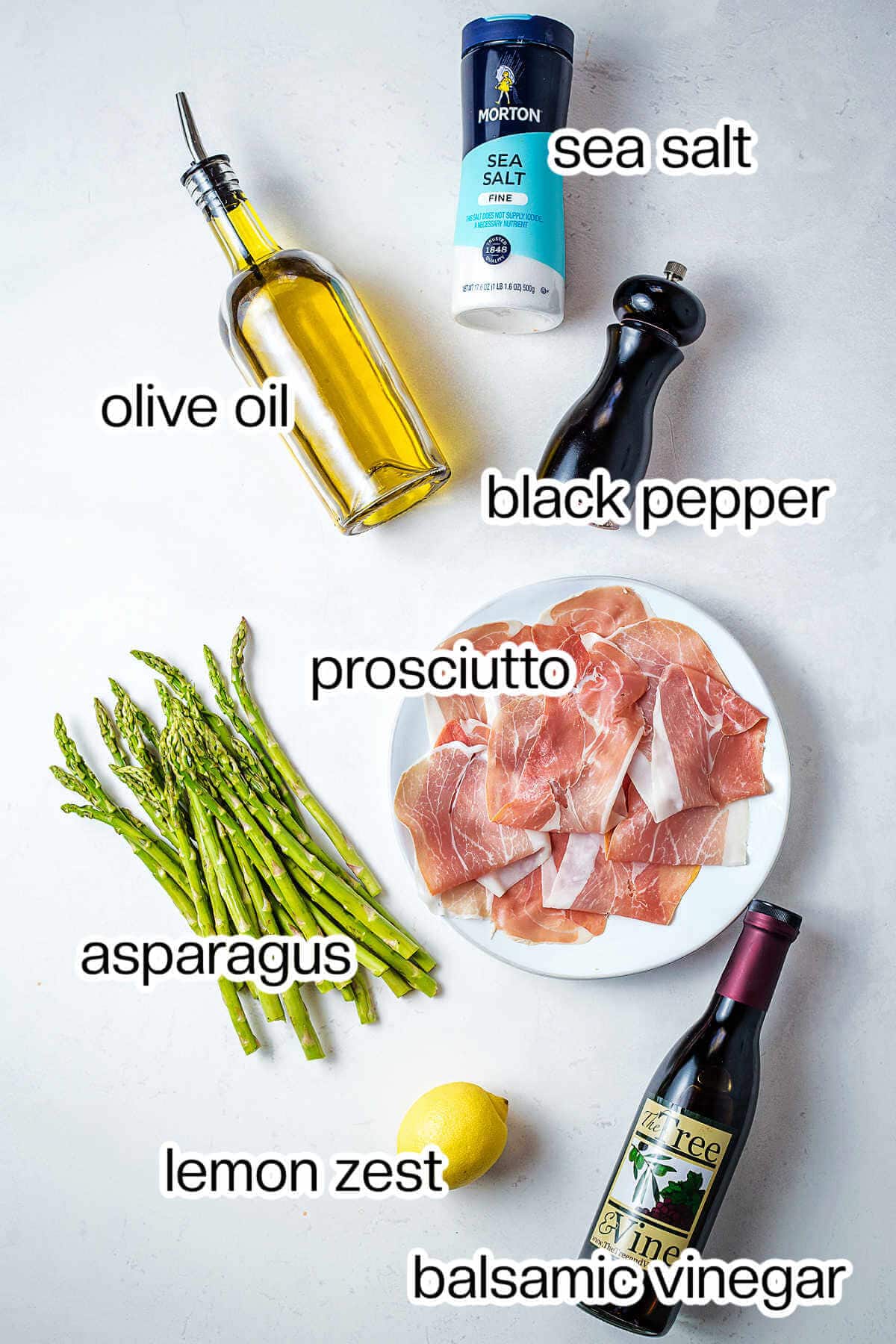 Ingredients for prosciutto wrapped asparagus on a table.