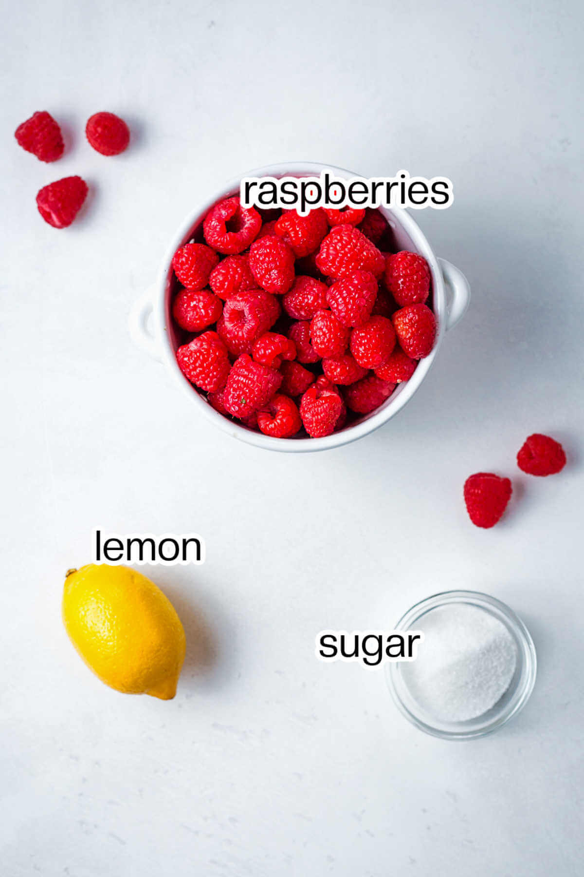 Ingredients for raspberry coulis on a table.