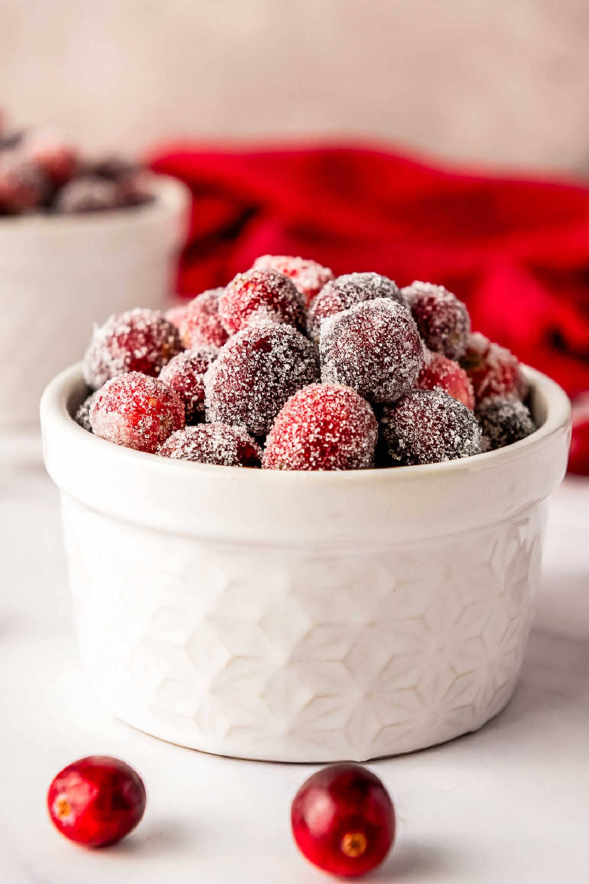 Side view of a bowl of candied cranberries.